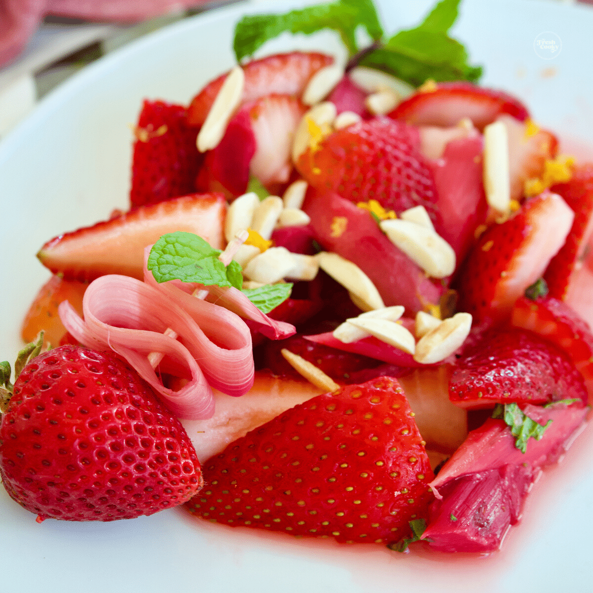 Strawberry rhubarb salad with pretty ribbon of rhubarb.