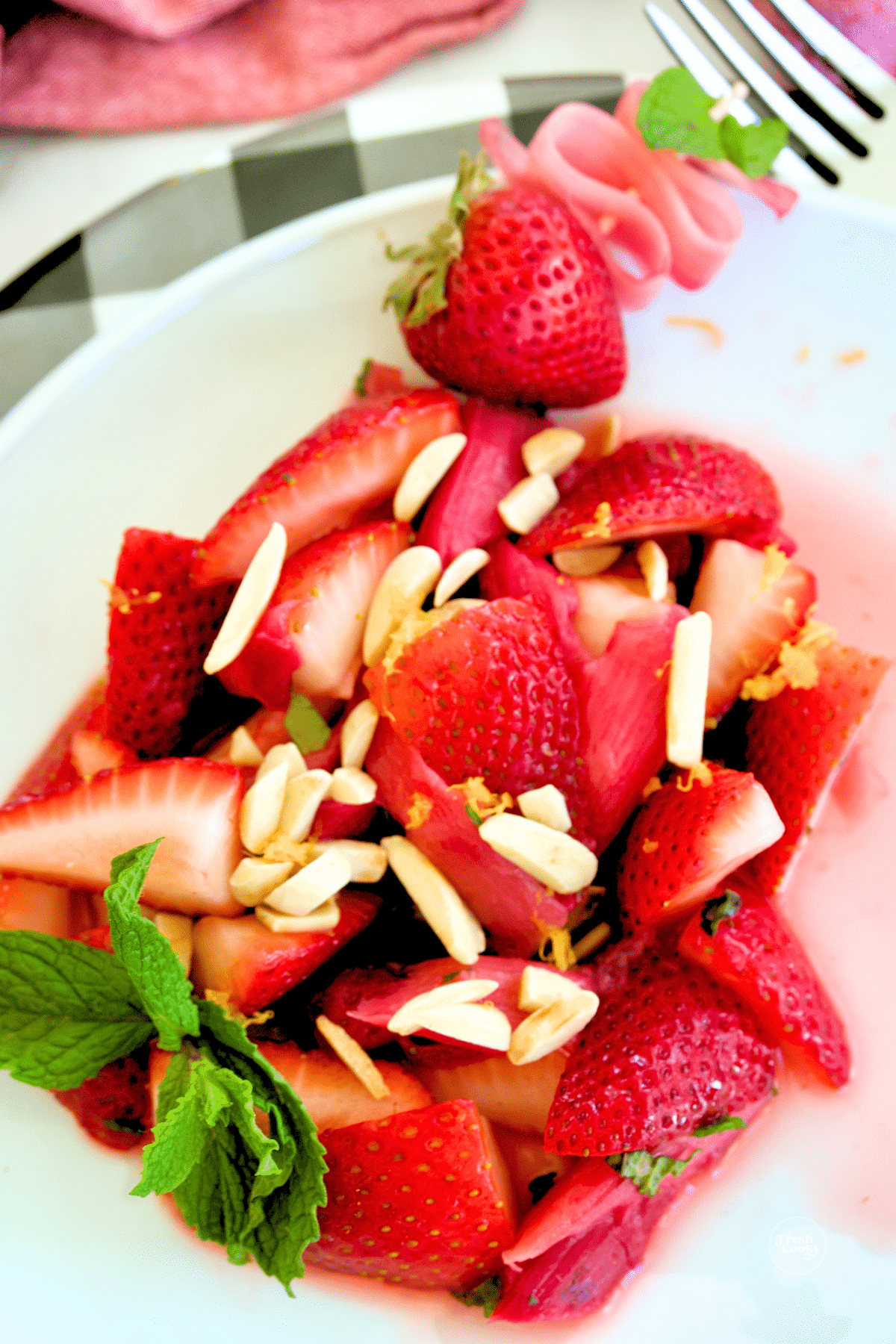 Strawberry Rhubarb Salad on plate with mint garnish.