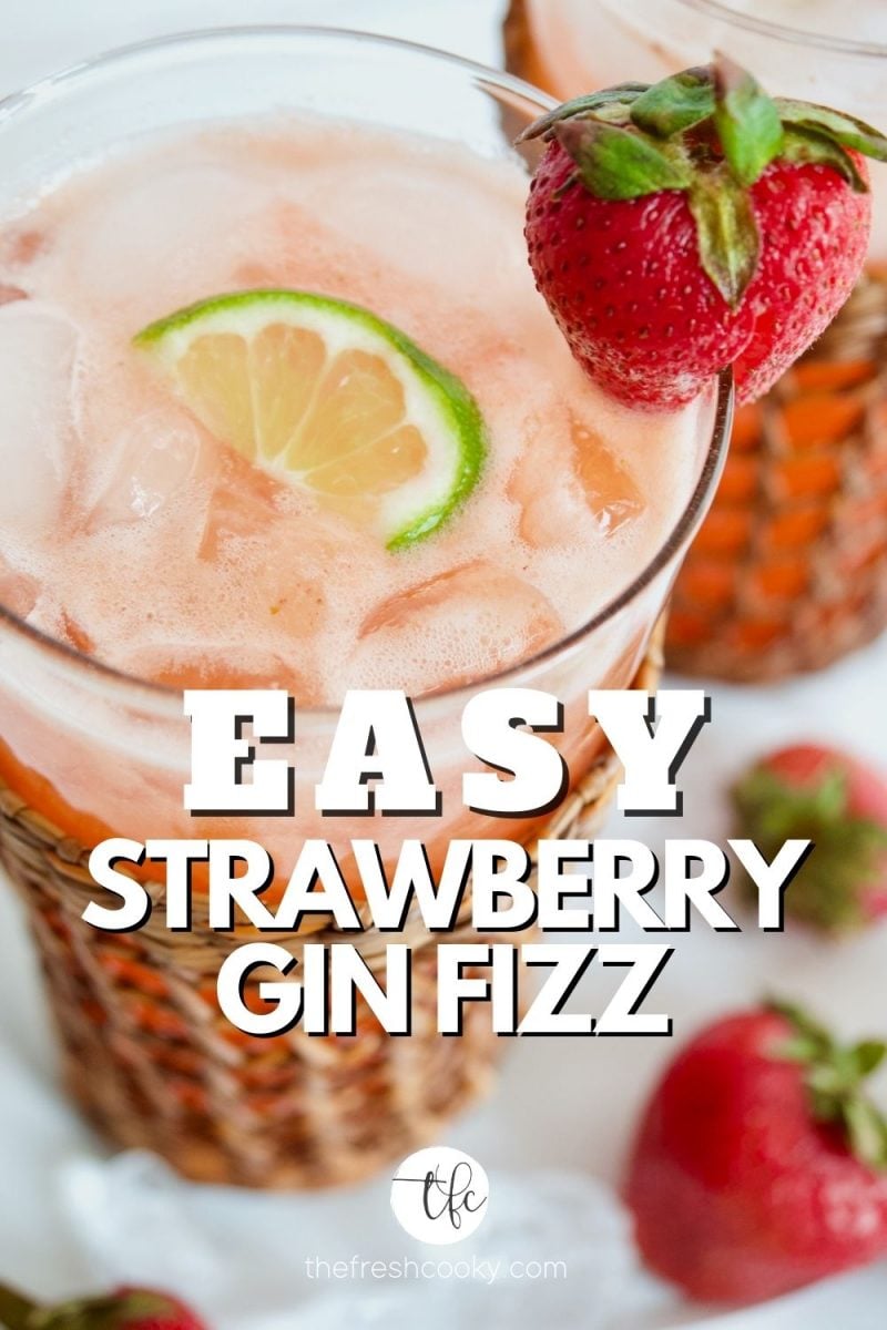 Easy Strawberry Gin Fizz with tall glass filled with a pink strawberry cocktail with strawberry garnish and lime wedge.