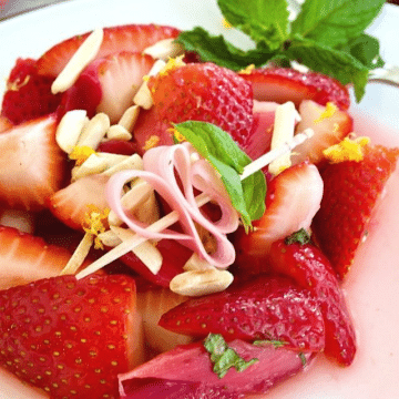 Strawberry Rhubarb Salad on a plate dressing with fresh mint.