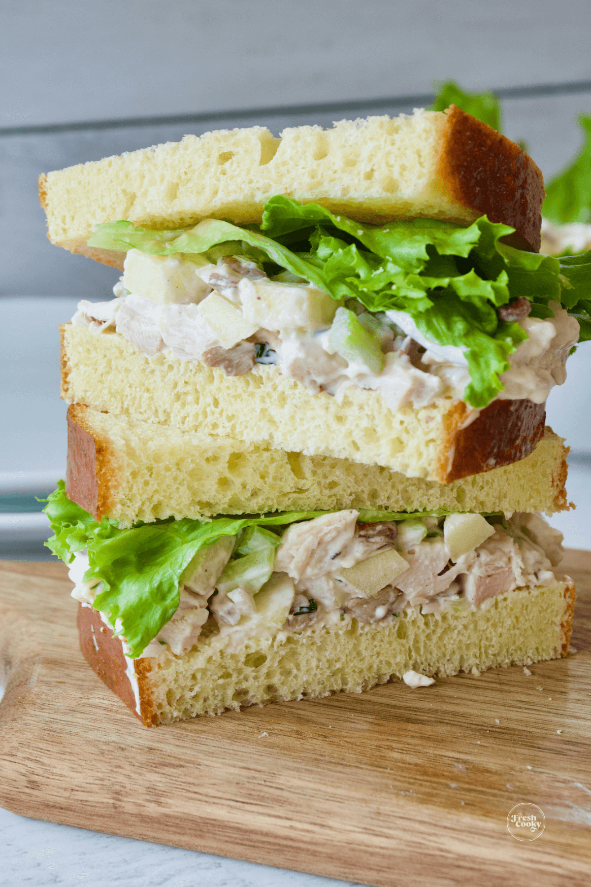 Chicken salad sandwich on brioche bread with lettuce. 