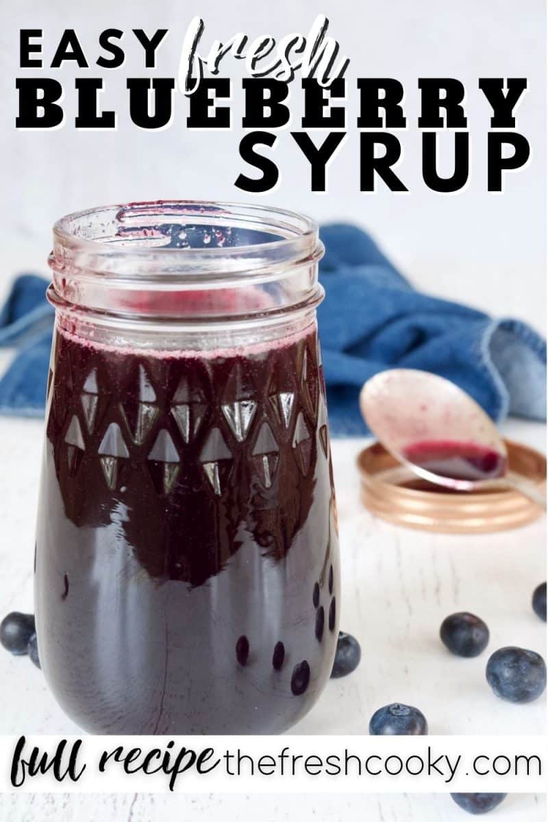 Pin for easy fresh blueberry syrup with closeup of jar of blueberry syrup with spoon in background and fresh blueberries around.