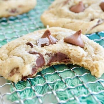 Best Gluten Free Chewy Chocolate Chip Cookies on wire rack with bite taken out of cookie.