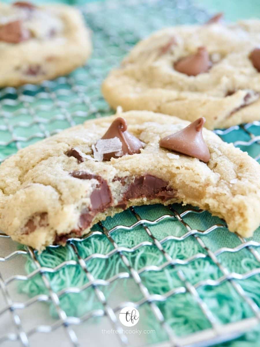 Best Gluten Free Chewy Chocolate Chip Cookies on wire rack with bite taken out of cookie.