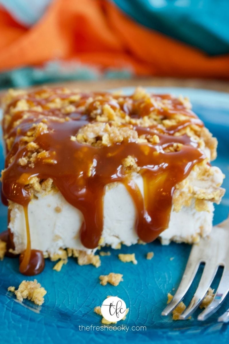 Slice of fried ice cream cake on brightly colored plate with caramel and chocolate drizzle.