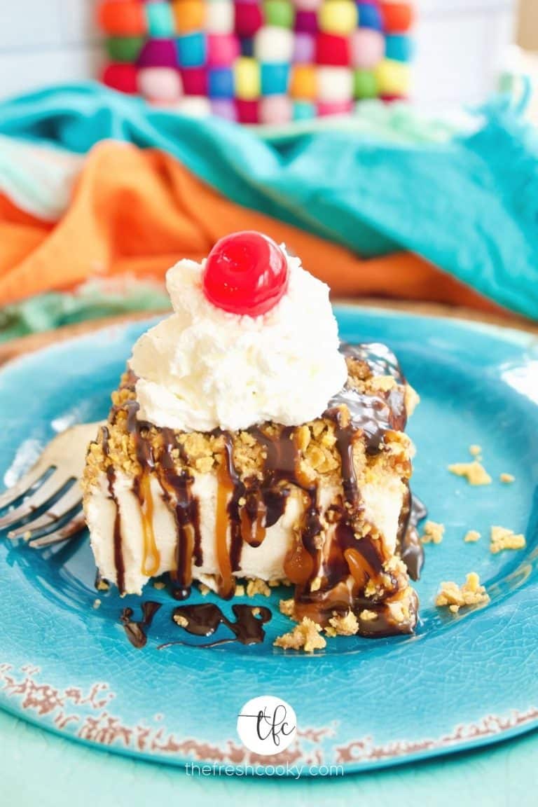 Best fried ice cream cake with caramel and chocolate drizzle, whipped cream and a cherry on top, amongst brightly colored plates and napkins.