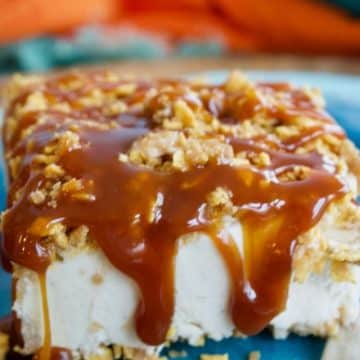 Slice of fried ice cream cake on brightly colored plate with caramel and chocolate drizzle.