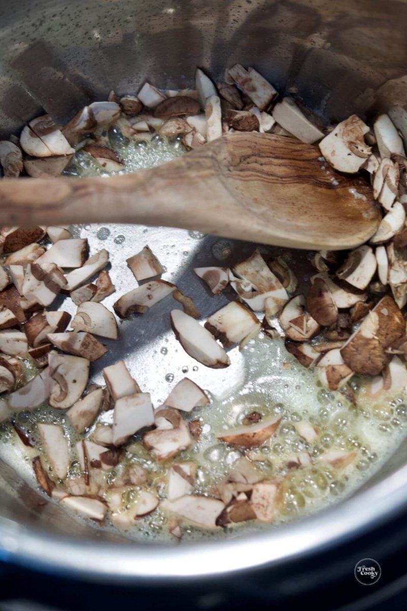 Saute mushrooms in butter in Instant Pot for farfalle pasta. 