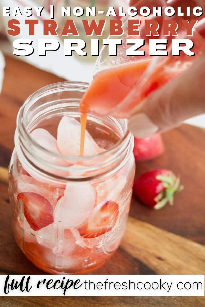 Refreshing strawberry spritzer with hand pouring strawberry syrup into glass with ice.