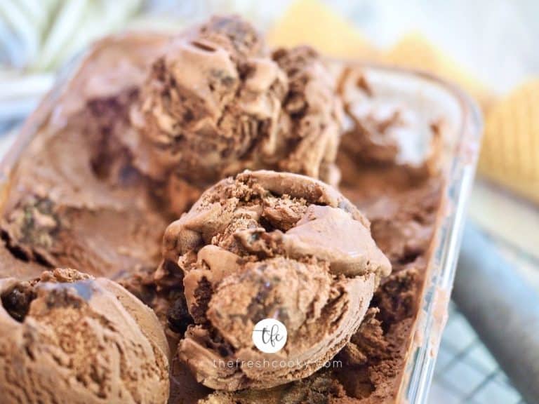 Close up of scooped chocolate brownie ice cream with scoop in background.