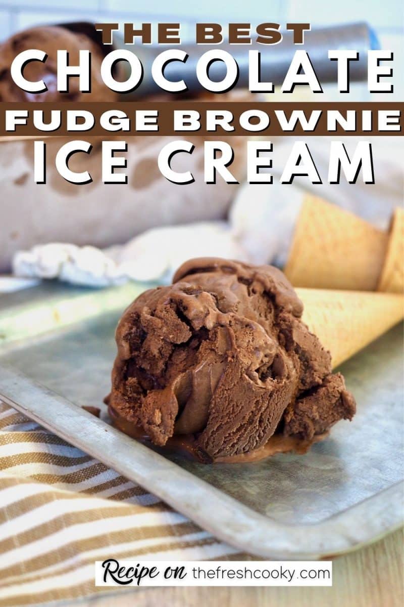 Large scoop of chocolate brownie ice cream on a sugar cone, laying on a galvanized silver tray.