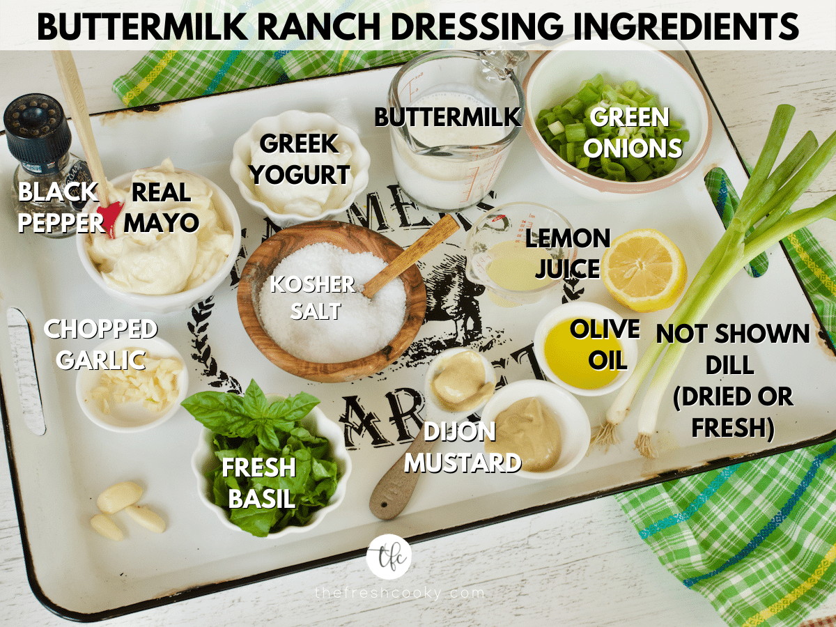 Ingredient shot labeled for Buttermilk Ranch Dressing L-R Black pepper, mayo, Greek yogurt, buttermilk, chopped green onions, olive oil, lemon juice, dijon mustard, kosher salt, basil leaves, garlic and not shown is dill leaves.