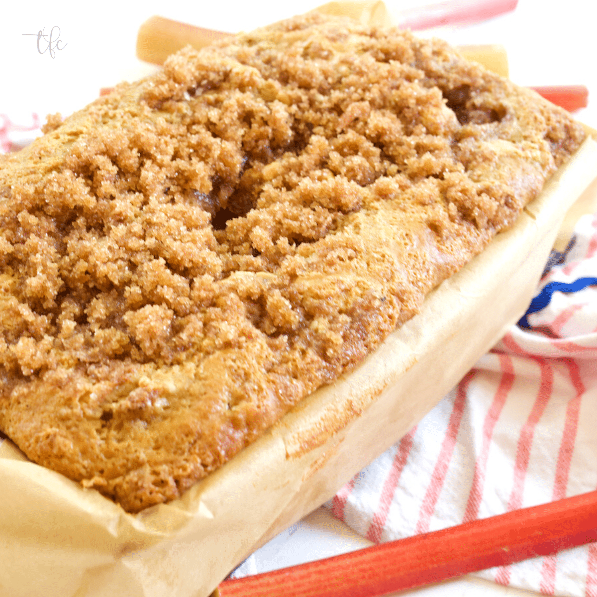 Buttermilk rhubarb bread in loaf pan with cinnamon streusel topping.