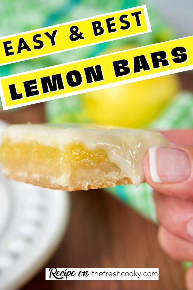East Best Lemon Bars or Lemon Squares, with hand holding a gooey lemon square.