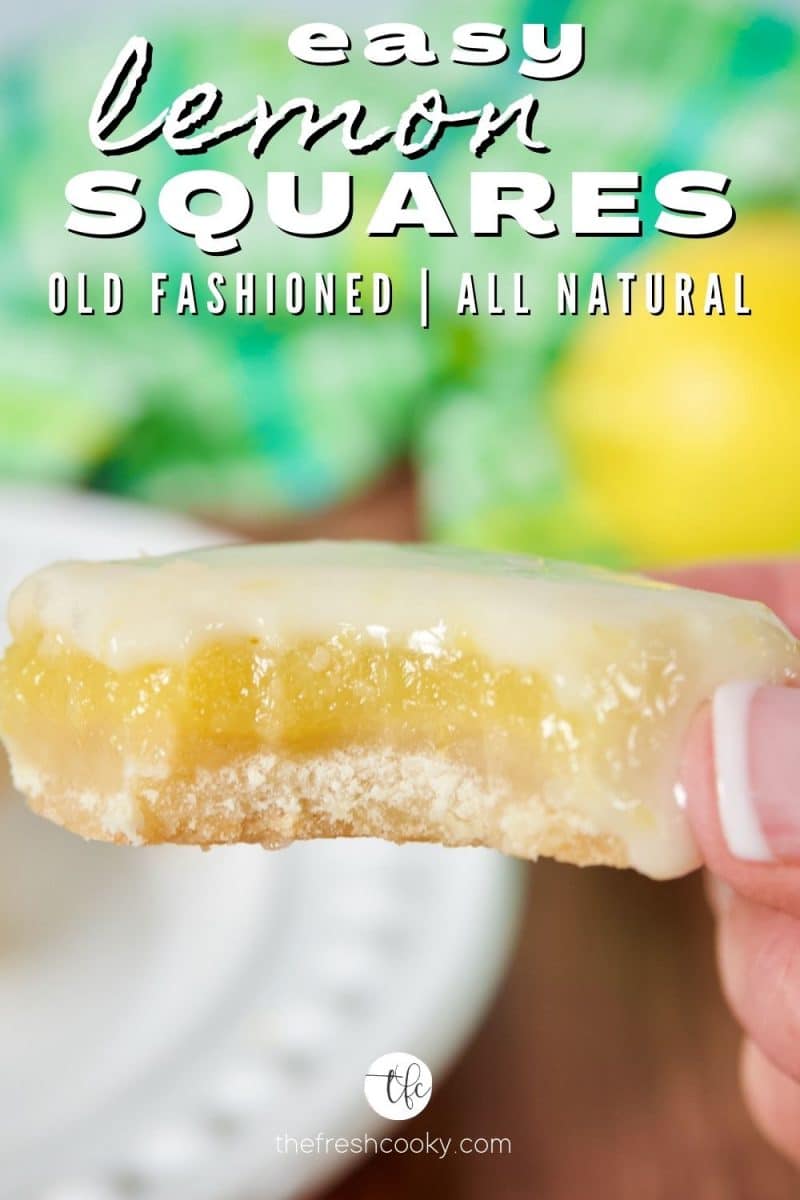 Easiest lemon squares recipe with a hand holding a lemon square with a bite taken out.