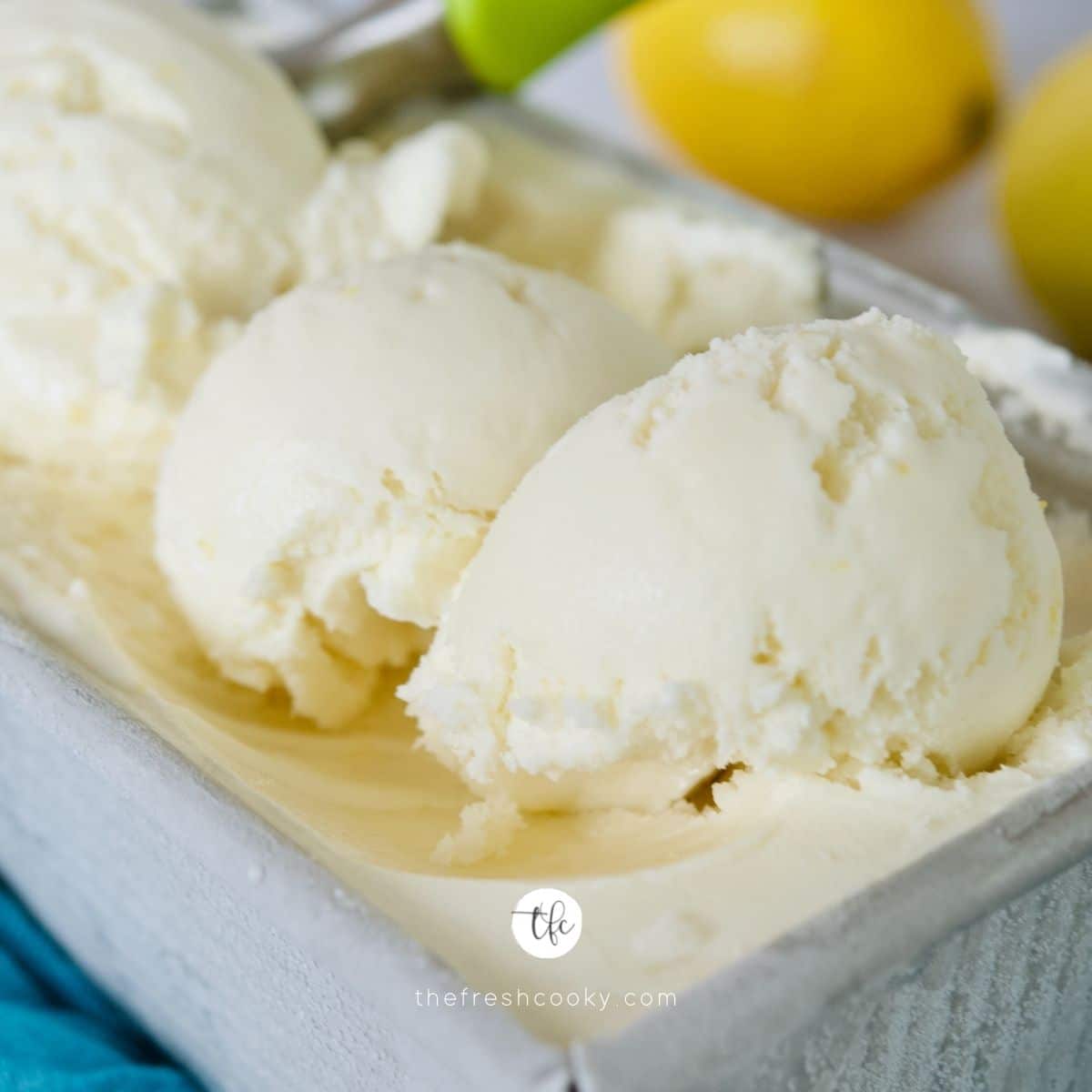 Close up square image for Lemon Ice Cream or Lemon Gelato, three scoops made of cremy lemon ice cream in loaf pan.