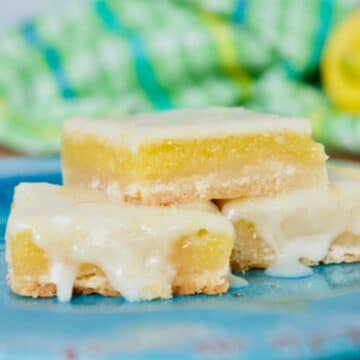 A pate of light and gooey old fashioned lemon squares on a blue plate.