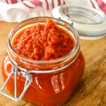 Square image of best pizza sauce in glass sealing jar with lid.