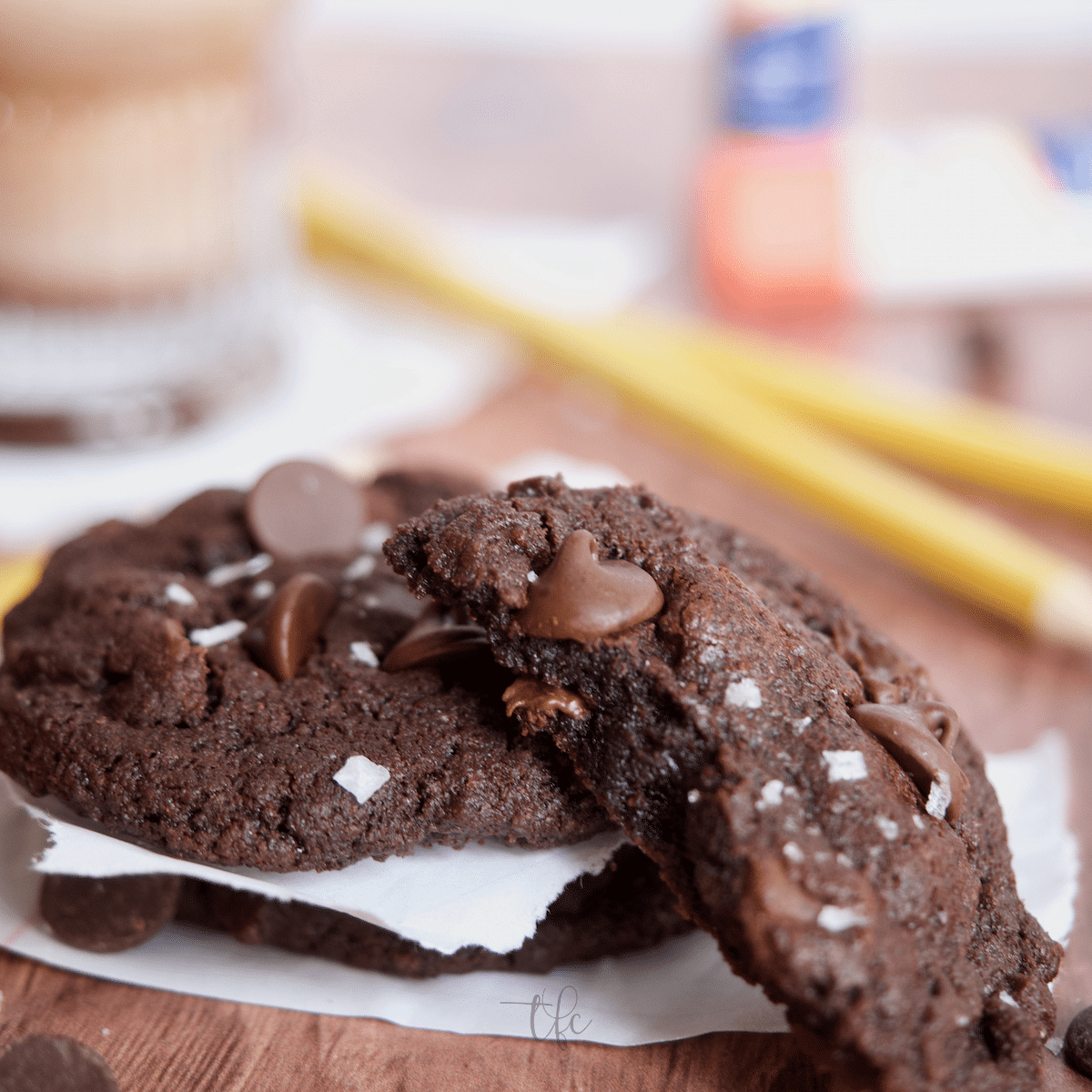 Triple Chocolate Cookies with one broken open to reveal a dark, fudgy center. 