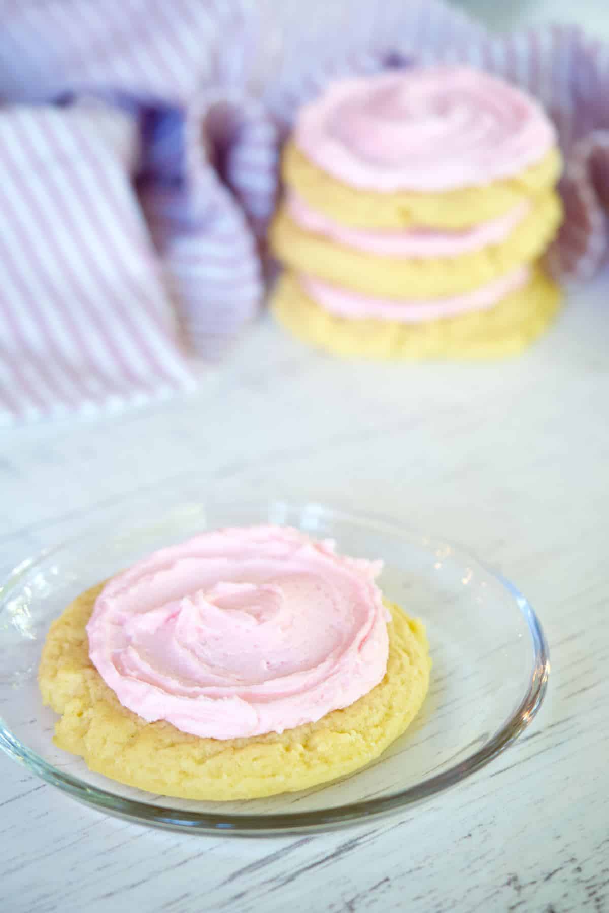 Copycat crumbl sugar cookie on plate with stack behind.