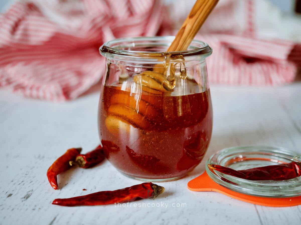 Facebook image for hot honey with image of honey in a pretty tulip shaped jar with honey dipper.