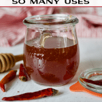DIY Hot Honey recipe pin with image of jar of hot honey with chili peppers around.