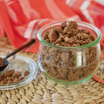 Graham Cracker Crumble Crunch Topping in pretty shaped jar with spoon and crumble nearby.