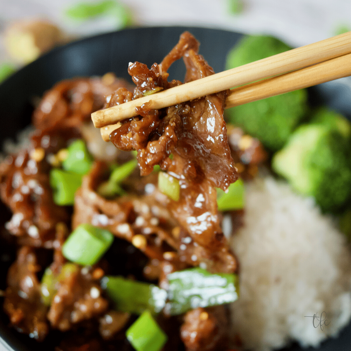 Mongolian Beef Recipe chopsticks grabbing a tender slice of beef.