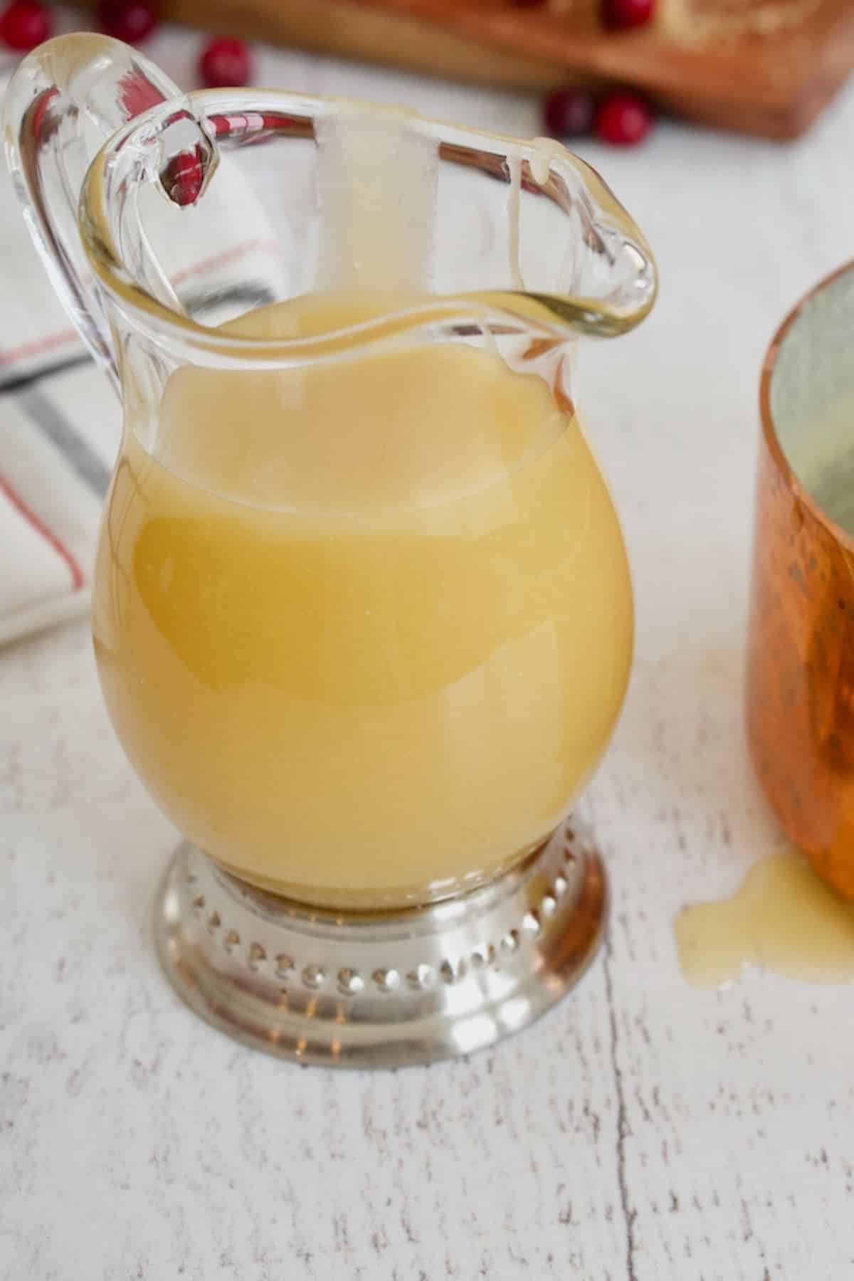 Vanilla sauce in small glass pitcher.