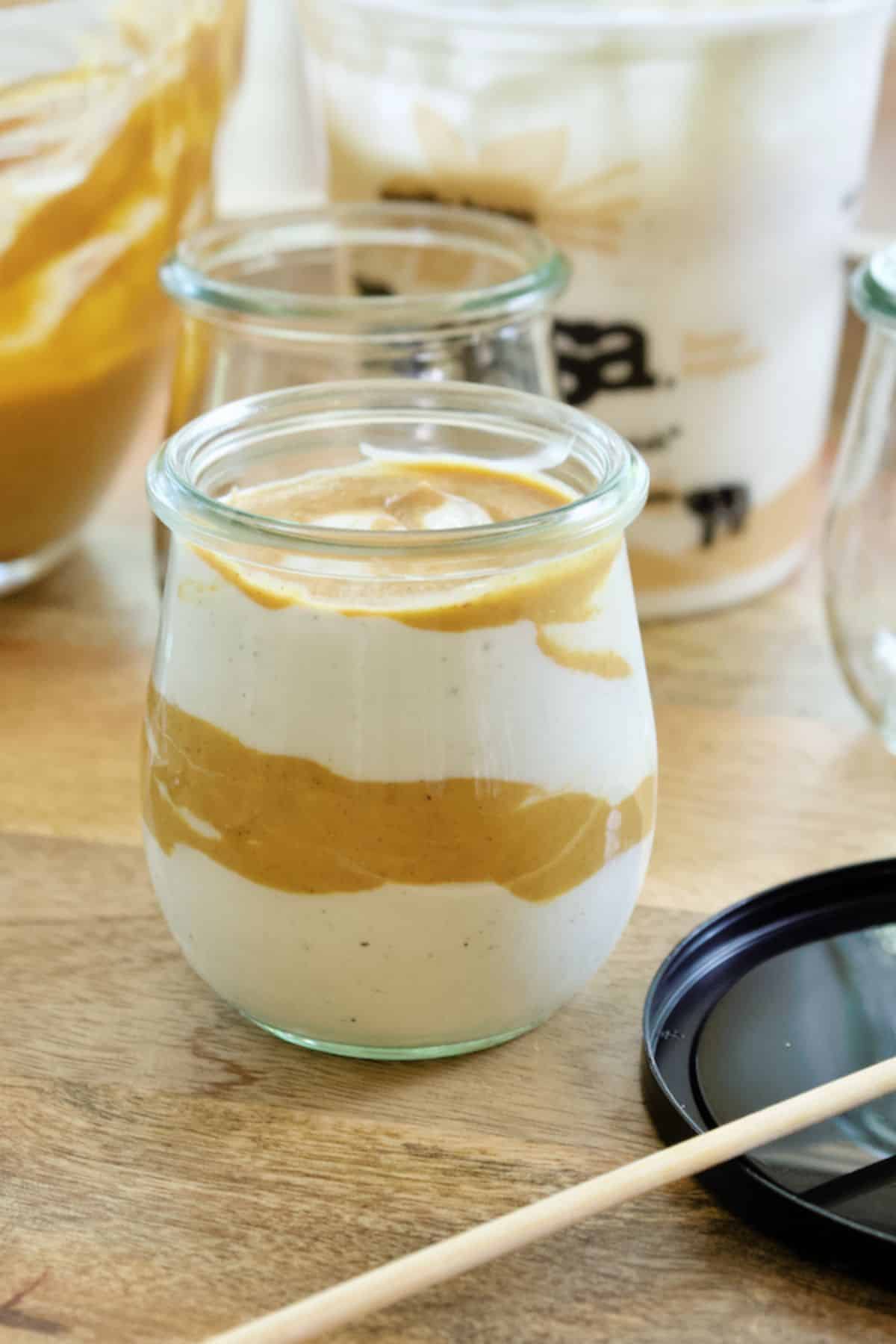 Layered noosa pumpkin yogurt in jar.