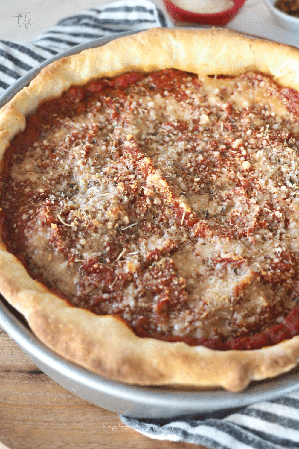 Chicago-Style Deep Dish Pizza in pan after baking with golden crust.