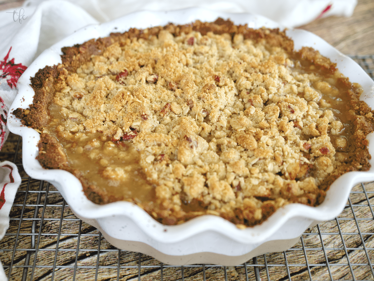 freshly baked, bubbling and juicy gluten-free apple pie on cooling rack.