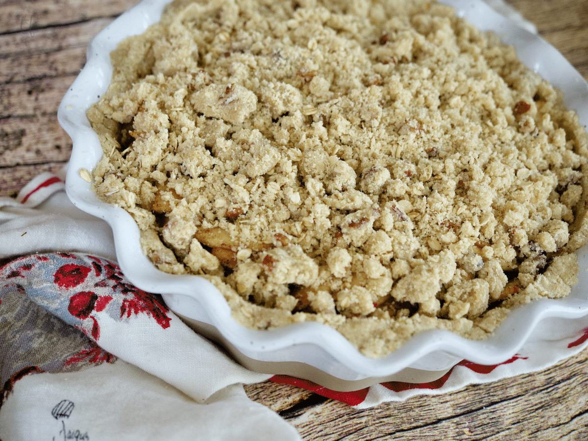 Image of gluten-free apple pie with crumb topping ready to be baked. 