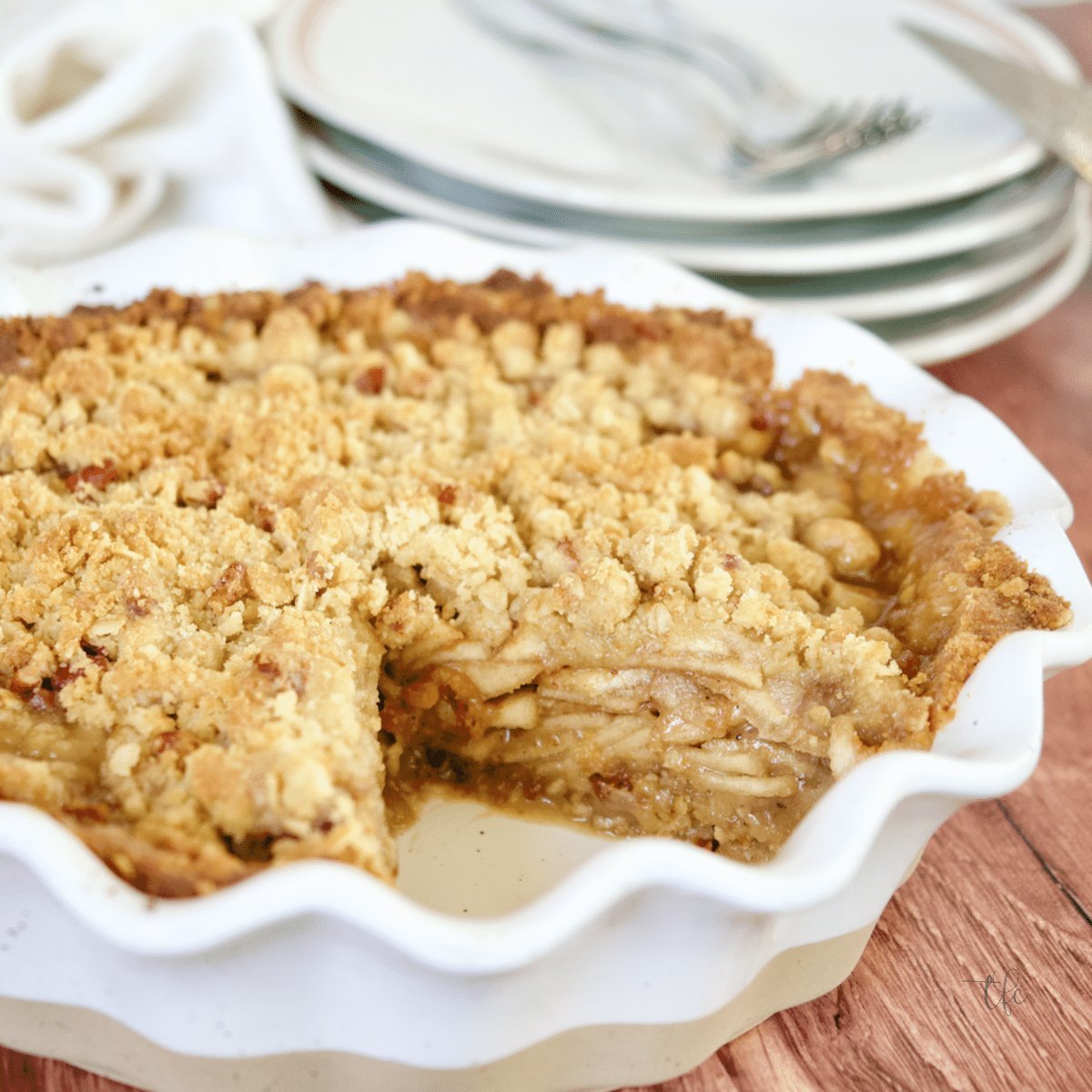 Gluten-Free Apple pie with slice removed revealing juicy layers of apples square image.