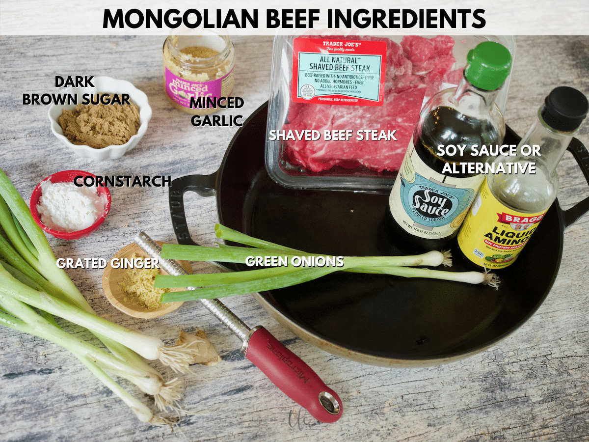 Mongolian Beef image of ingredients L-R green onions, cornstarch, dark brown sugar, minced garlic, shaved beef steak, soy sauce and minced ginger.