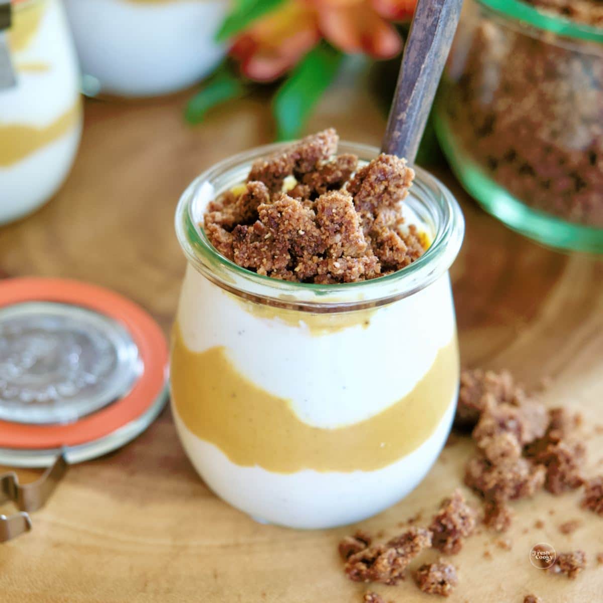 Pumpkin Spice Yogurt in jar layered into a parfait and topped with graham cracker crumble.