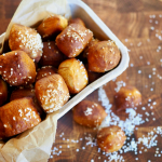 Pretzel bites in basket with pretzel salt around, for air fryer or oven baked pretzel bites.