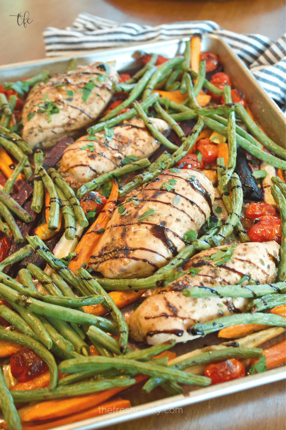 Easy Balsamic Maple Chicken Sheet pan dinner with carrots and green beans and a balsamic glaze drizzle.