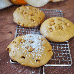 Soft Pumpkin Cookies on wire rack being dusted with powdered sugar.