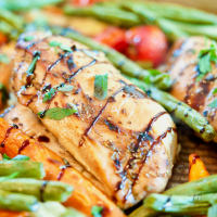 Balsamic Maple Chicken and Veggie Sheet Pan dinner, close up with green beans, carrots and tomatoes.