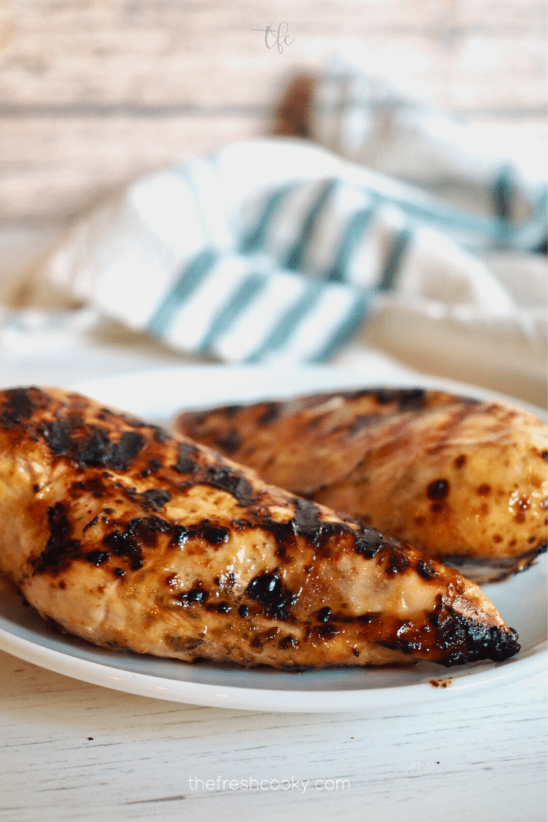 apple cider marinated grilled chicken breasts on a plate. 