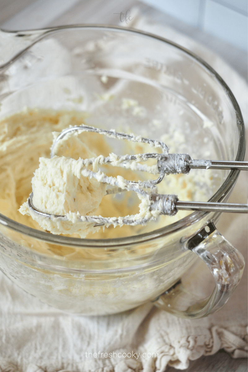 Whipping cream cheese and sugar until light and fluffy.