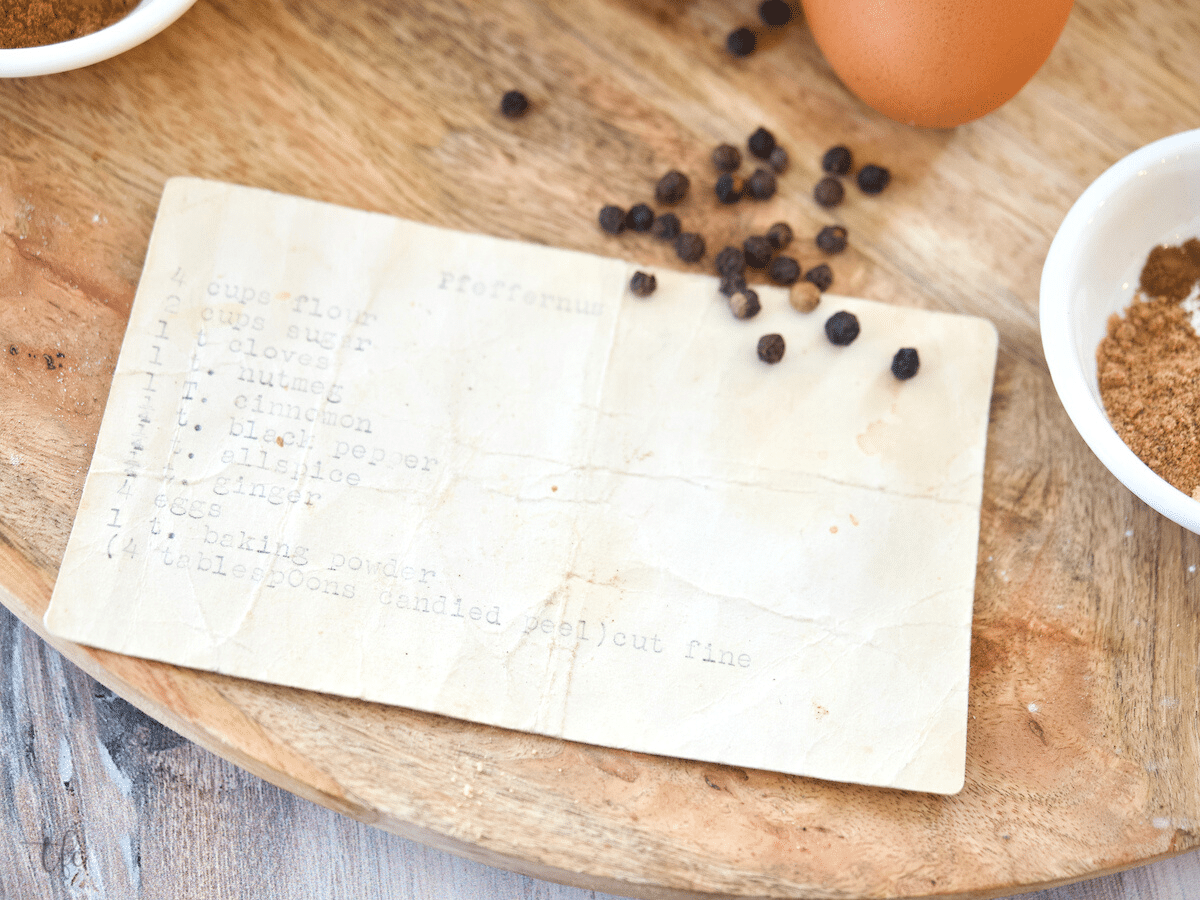 Original family recipe typed onto a 3x5 card, barely visible with peppercorns and other spices nearby.