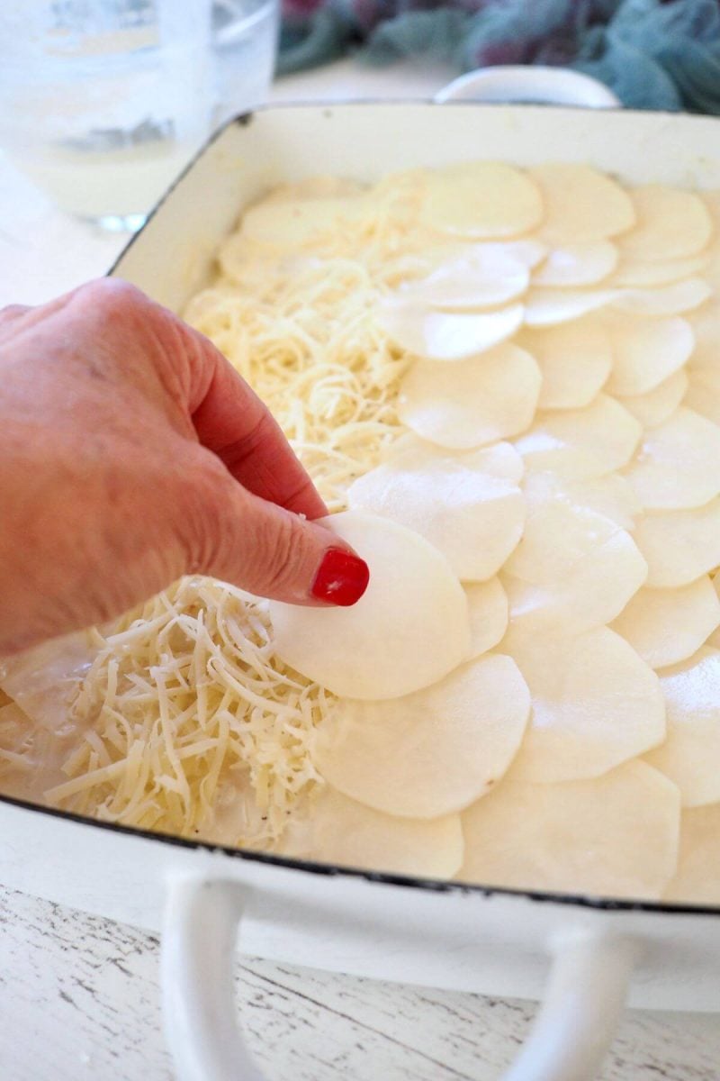 Repeating the potatoes layering over the cheese. 