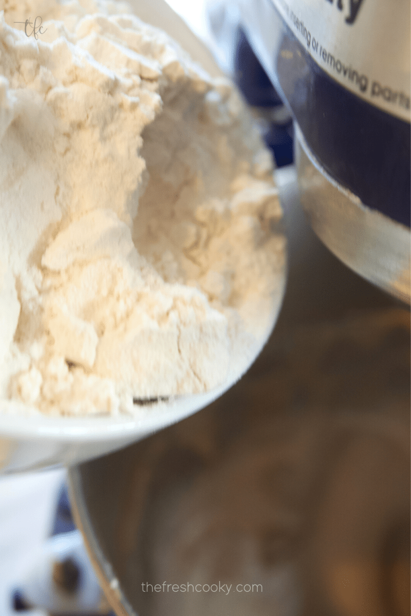 Mixing flour and baking powder into batter for pfeffernusse cookies. 