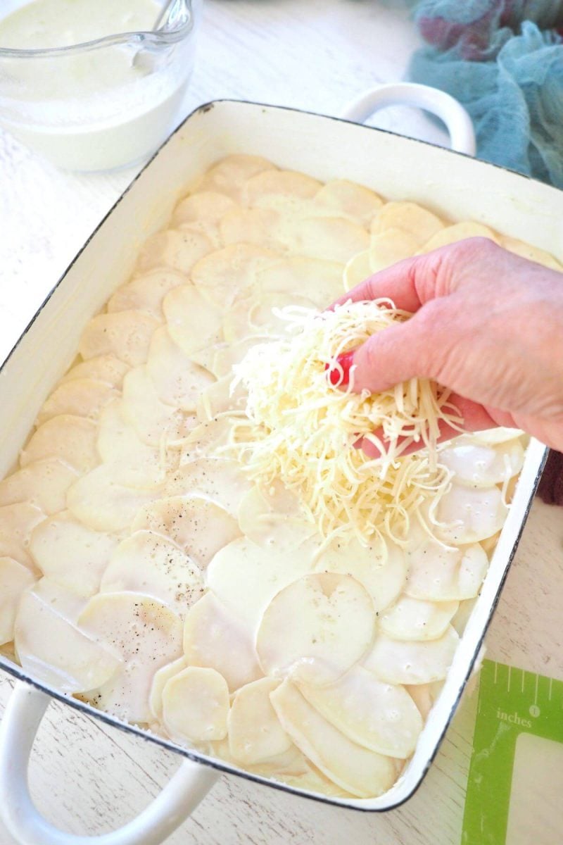 Add layer of shredded gruyere cheese on top of potatoes.