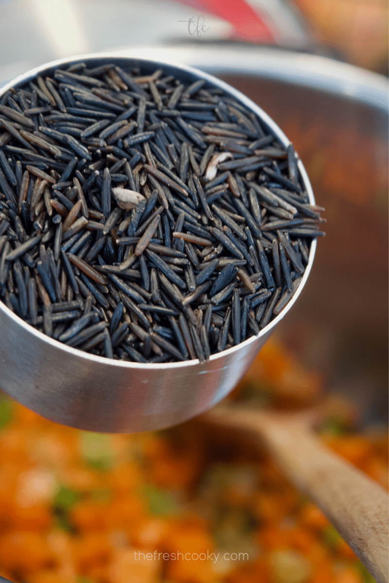 Adding wild rice to the Instant Pot for chicken and wild rice soup. 