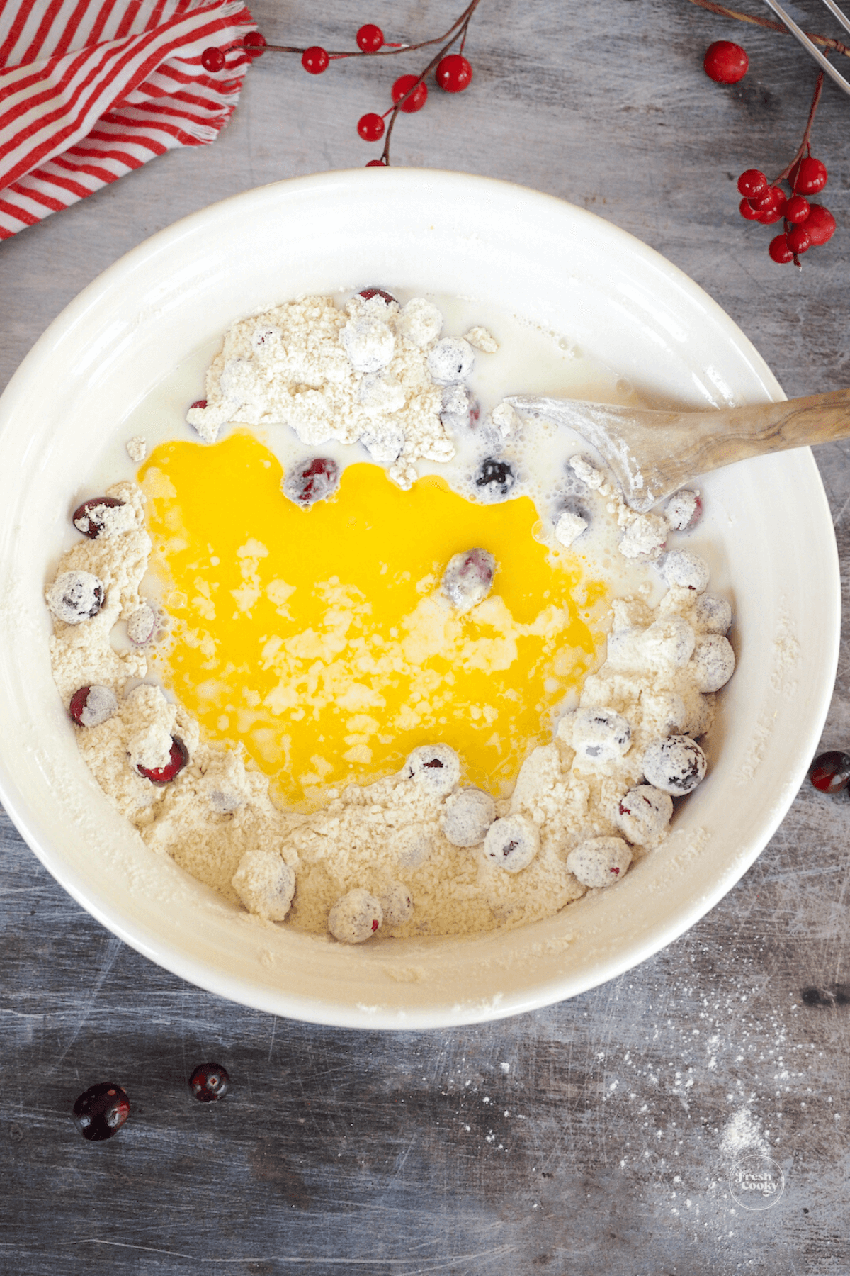 Stir in melted butter to cranberry cake batter. 