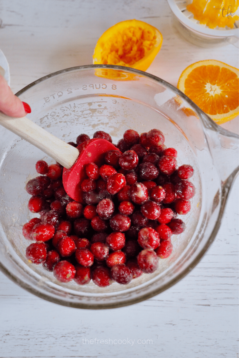 Gently stirring to mix and dissolve sugars into cranberry topping. 