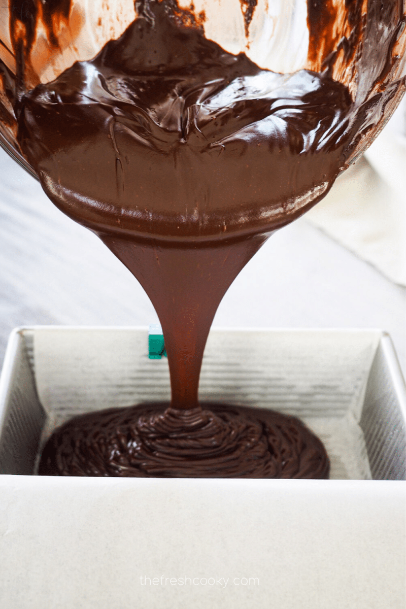  Pouring chocolate champagne truffle batter into lined pan.